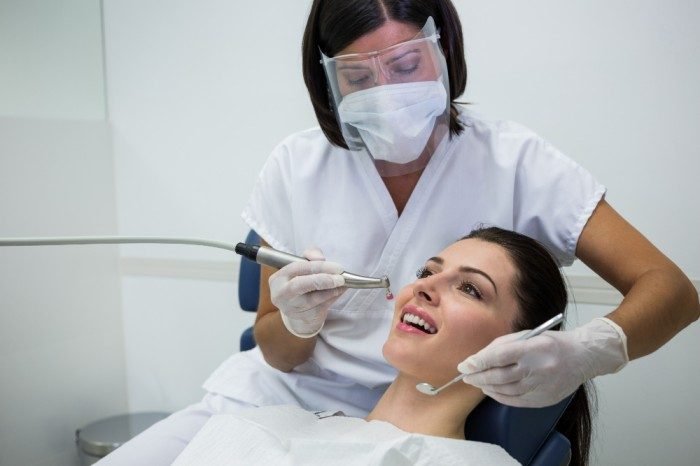 Dentist checking patient teeth